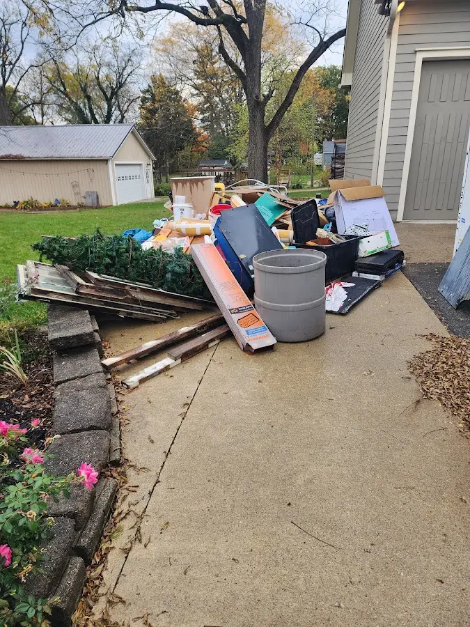Dumpster being loaded with debris for Residential Dumpster Rental in Armada